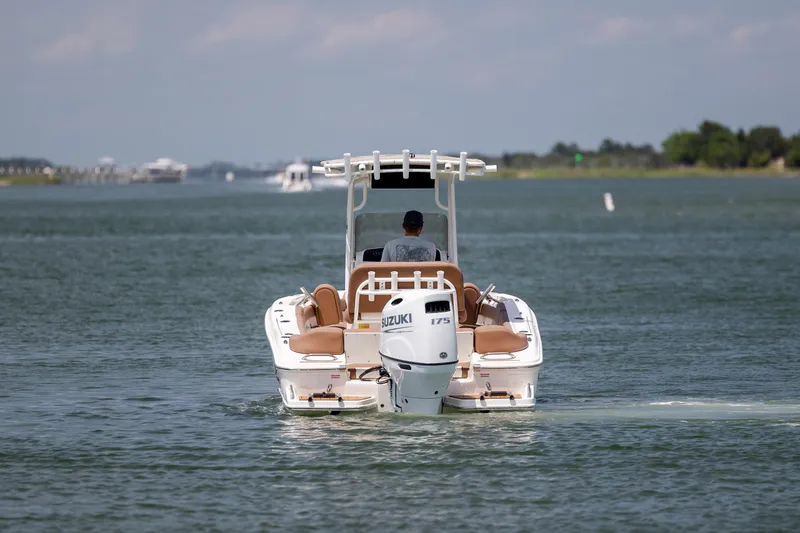 Slide: The Image of 2022 Pioneer 202 Islander boat cruising on a calm waterway. - 5