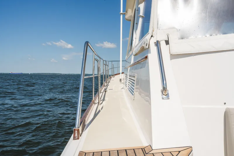 Slide: The Image of Side view of 1999 Grand Banks 49 Eastbay HX yacht on open water. - 17