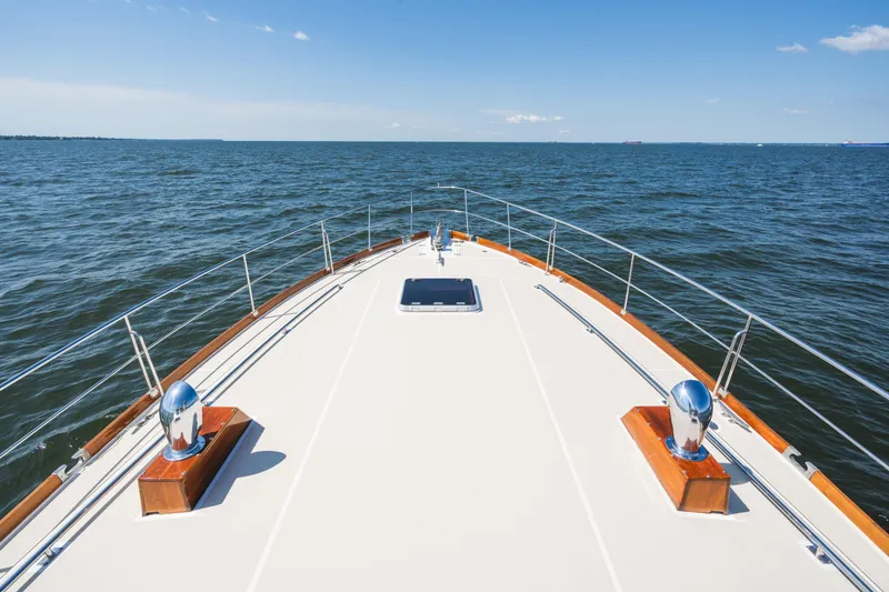 Slide: The Image of Bow view of 1999 Grand Banks 49 Eastbay HX yacht on open water. - 22