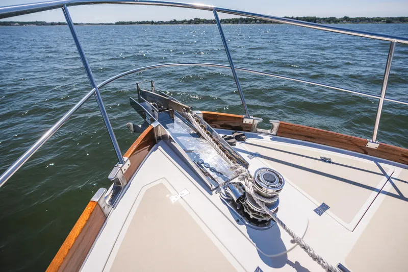 Slide: The Image of Bow of 1999 Grand Banks 49 Eastbay HX yacht on open water. - 23