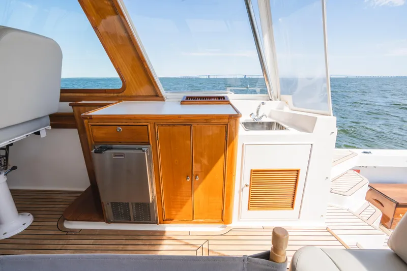 Slide: The Image of 1999 Grand Banks 49 Eastbay HX yacht interior with kitchenette and ocean view. - 28