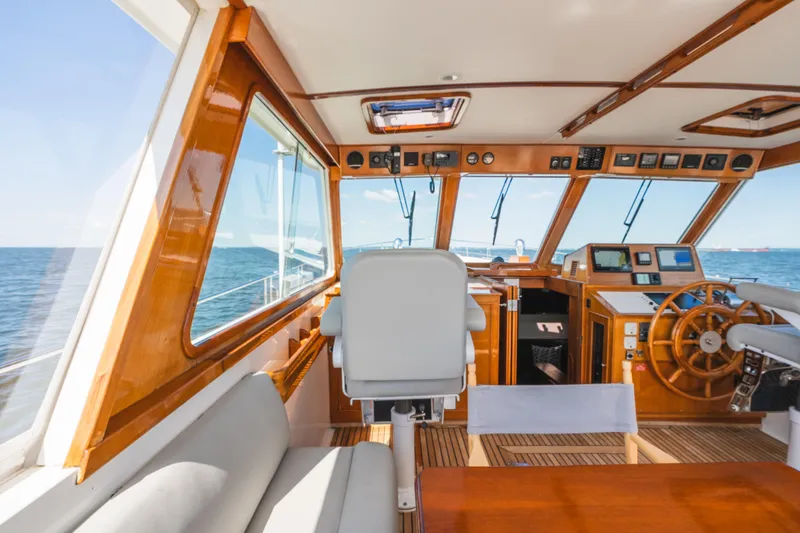 Slide: The Image of Interior view of 1999 Grand Banks 49 Eastbay HX yacht helm with ocean backdrop. - 29