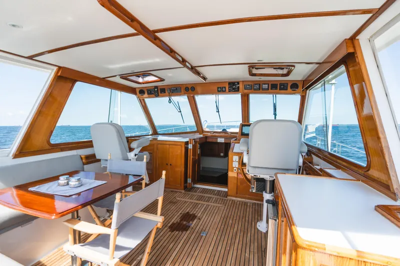 Slide: The Image of Interior of 1999 Grand Banks 49 Eastbay HX yacht with wooden finishes and ocean view. - 30