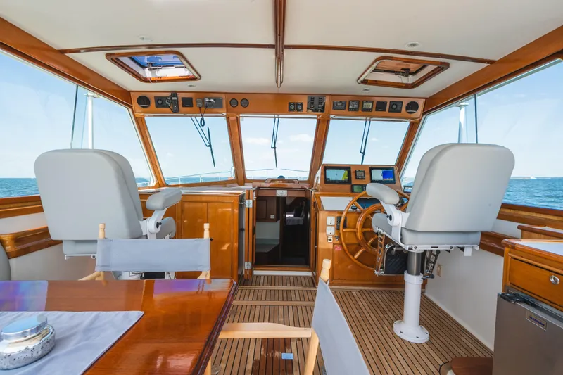 Slide: The Image of Interior of 1999 Grand Banks 49 Eastbay HX yacht with wooden helm and ocean view. - 31