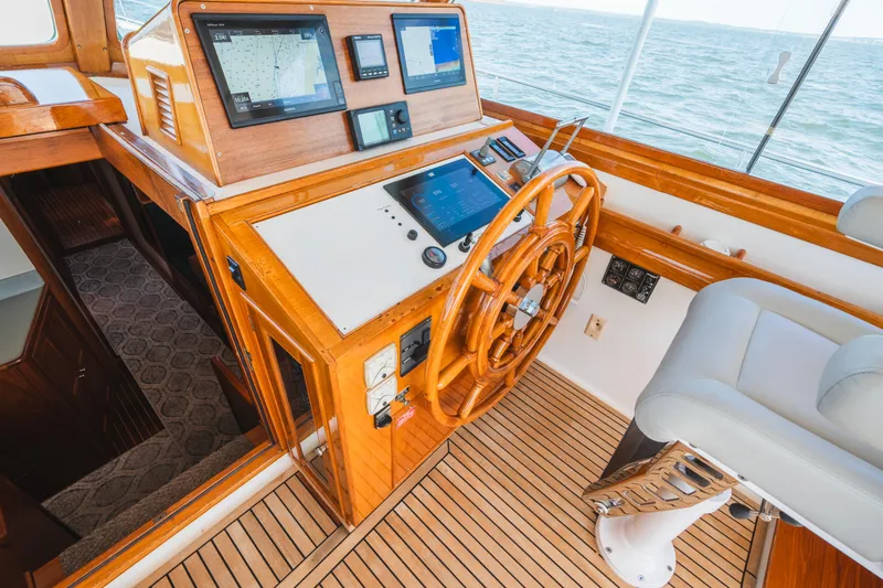 Slide: The Image of Helm of 1999 Grand Banks 49 Eastbay HX with wooden wheel and navigation screens. - 34