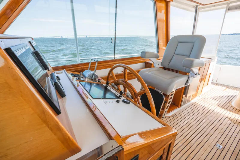 Slide: The Image of Helm of 1999 Grand Banks 49 Eastbay HX yacht with wooden steering wheel and captain's chair. - 36