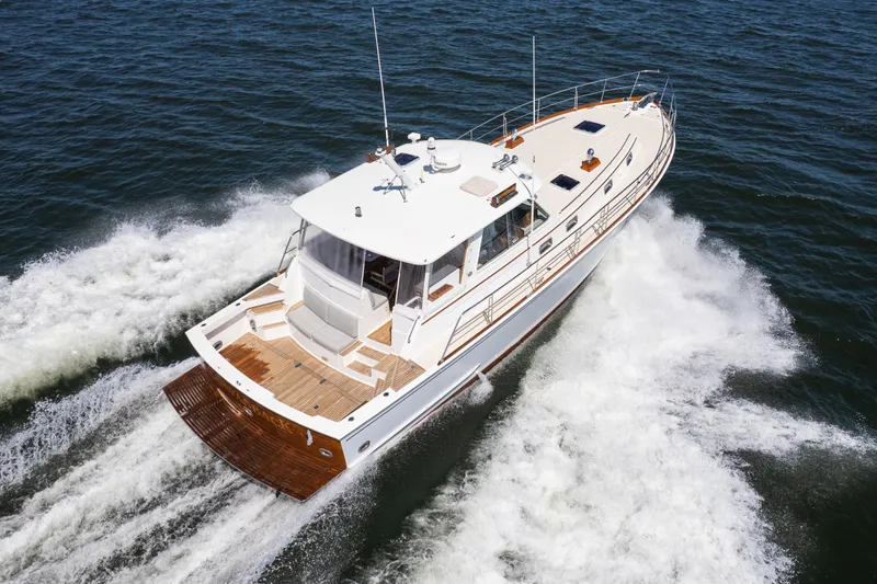 Slide: The Image of 1999 Grand Banks 49 Eastbay HX cruising on open water, showcasing elegant design and performance. - 4