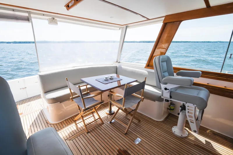 Slide: The Image of Luxurious 1999 Grand Banks 49 Eastbay HX yacht interior with seating and ocean view. - 41