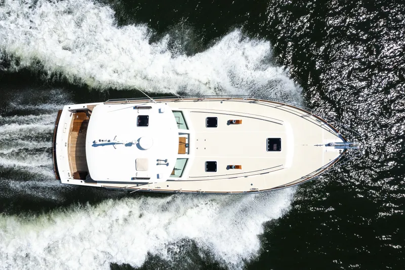 Slide: The Image of Aerial view of 1999 Grand Banks 49 Eastbay HX yacht cruising on water. - 5