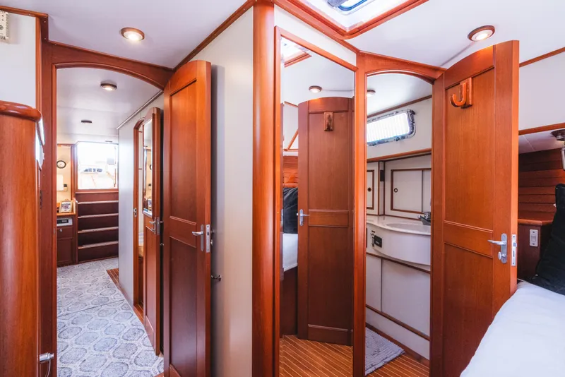 Slide: The Image of Interior of 1999 Grand Banks 49 Eastbay HX yacht with wooden doors and cozy cabin. - 50