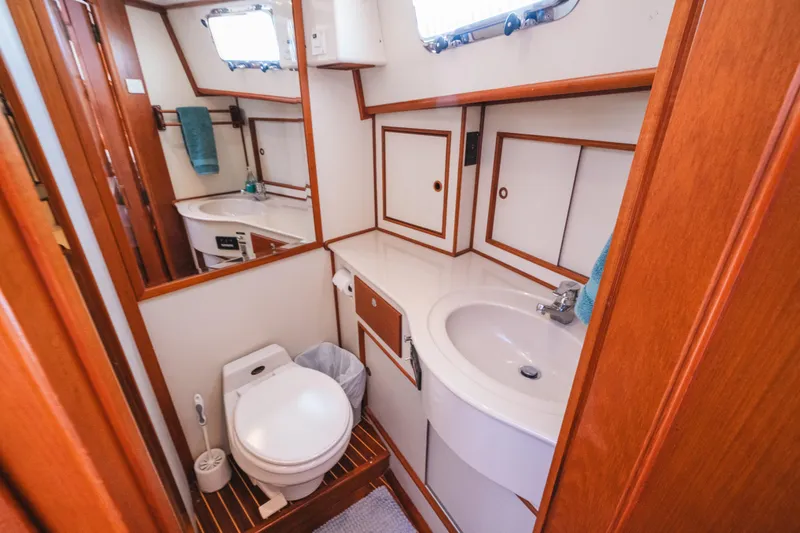 Slide: The Image of 1999 Grand Banks 49 Eastbay HX yacht bathroom with wooden accents and modern fixtures. - 51