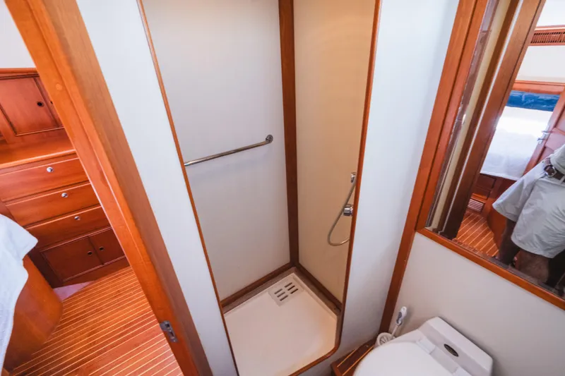 Slide: The Image of 1999 Grand Banks 49 Eastbay HX yacht bathroom with shower and wooden cabinetry. - 52