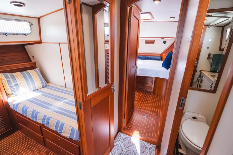 Slide: The Image of Interior of 1999 Grand Banks 49 Eastbay HX yacht with cozy wooden cabin and bathroom. - 54