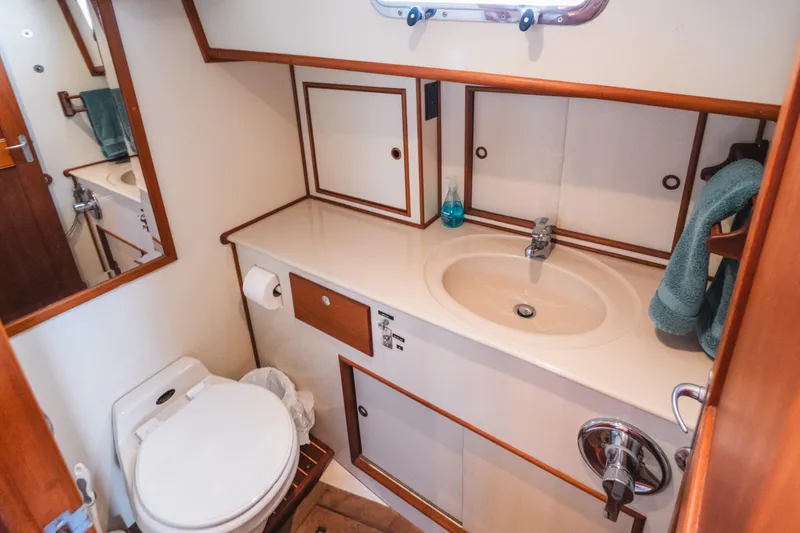 Slide: The Image of Bathroom interior of 1999 Grand Banks 49 Eastbay HX yacht, featuring sink and toilet. - 57