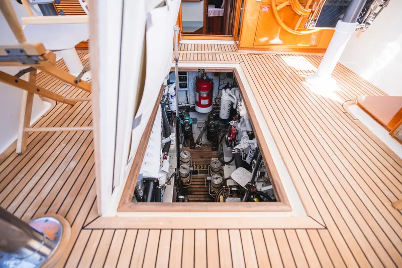 Slide: The Image of Engine room access on 1999 Grand Banks 49 Eastbay HX yacht with teak flooring. - 58