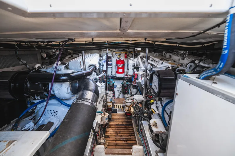 Slide: The Image of Engine room of 1999 Grand Banks 49 Eastbay HX, showcasing mechanical components and systems. - 60