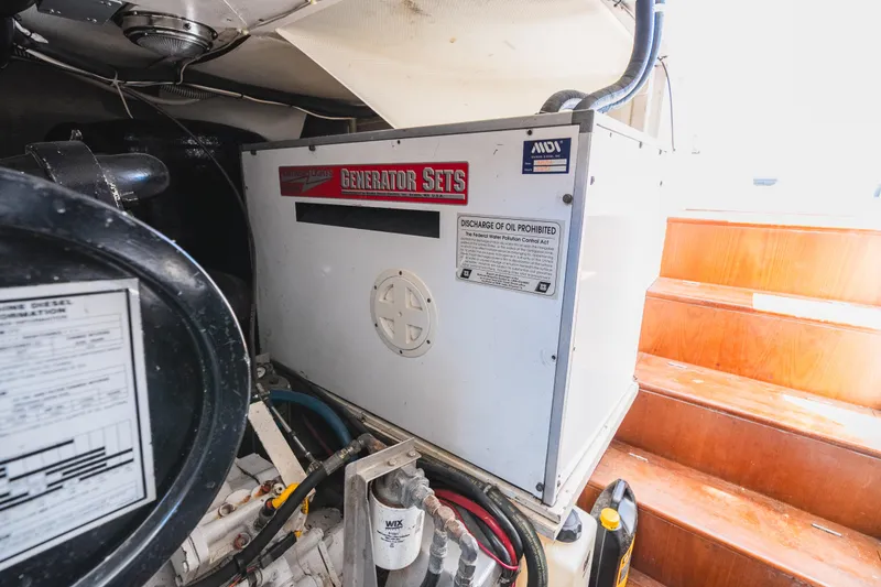 Slide: The Image of Engine room of 1999 Grand Banks 49 Eastbay HX with generator and equipment. - 62