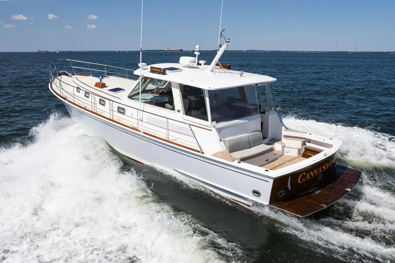 Slide: The Image of 1999 Grand Banks 49 Eastbay HX yacht cruising on open water. - 63