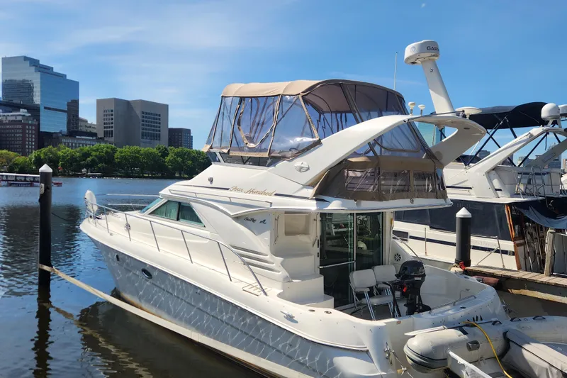 Slide: The Image of 2001 Sea Ray 400 Sedan Bridge yacht docked in urban marina setting. - 1