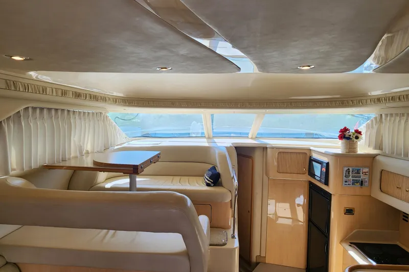 Slide: The Image of Luxurious interior of a 2001 Sea Ray 400 Sedan Bridge yacht with elegant seating and kitchenette. - 11