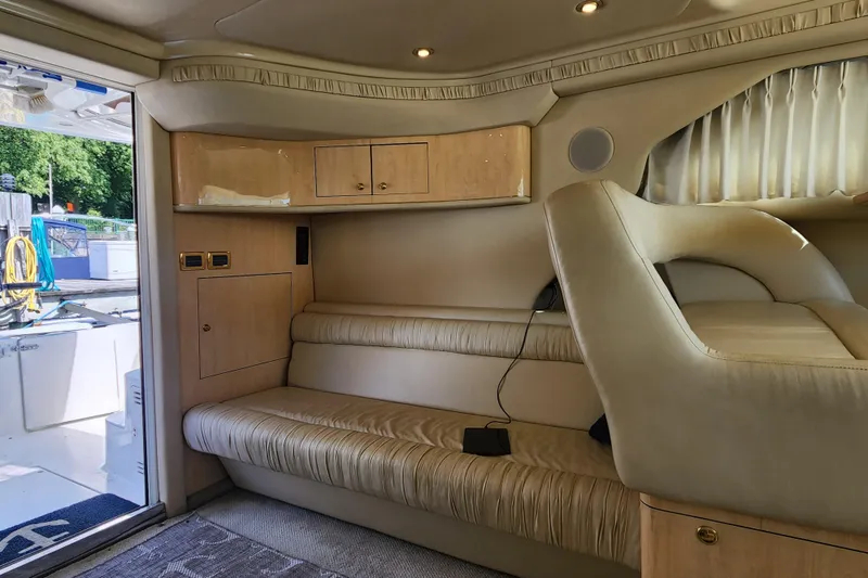 Slide: The Image of Interior of 2001 Sea Ray 400 Sedan Bridge yacht with beige seating and wooden cabinets. - 12