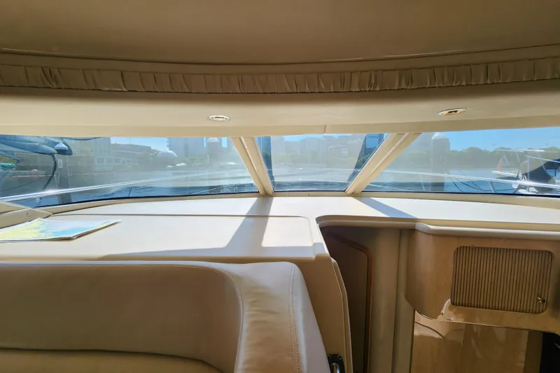 Slide: The Image of Interior view of 2001 Sea Ray 400 Sedan Bridge yacht cockpit with cityscape through windows. - 13