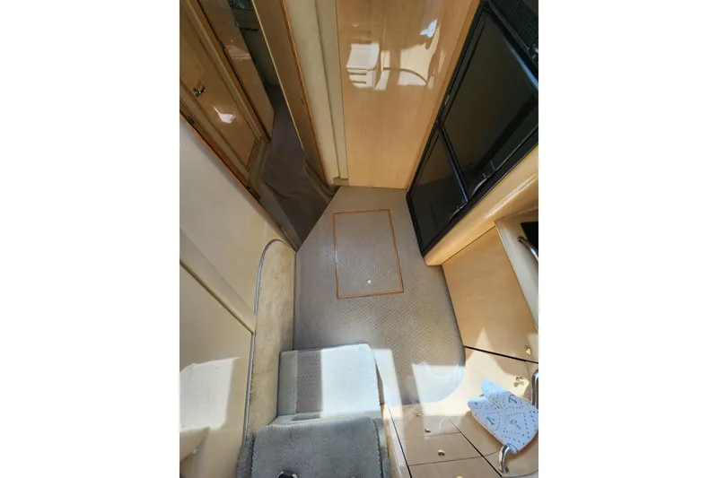Slide: The Image of Interior view of 2001 Sea Ray 400 Sedan Bridge yacht, featuring carpeted flooring and cabinetry. - 15