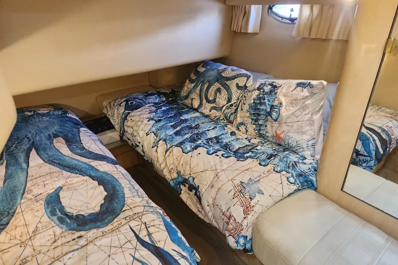 Slide: The Image of Nautical-themed bedroom in 2001 Sea Ray 400 Sedan Bridge yacht with octopus bedding. - 18