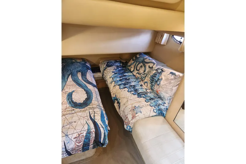 Slide: The Image of Interior cabin of 2001 Sea Ray 400 Sedan Bridge with nautical-themed bedding. - 19