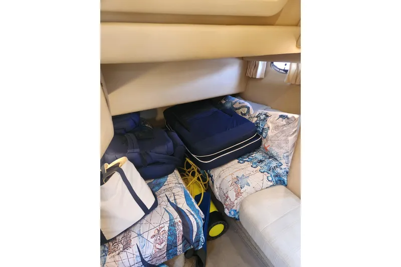 Slide: The Image of Interior cabin of 2001 Sea Ray 400 Sedan Bridge with nautical-themed bedding. - 20