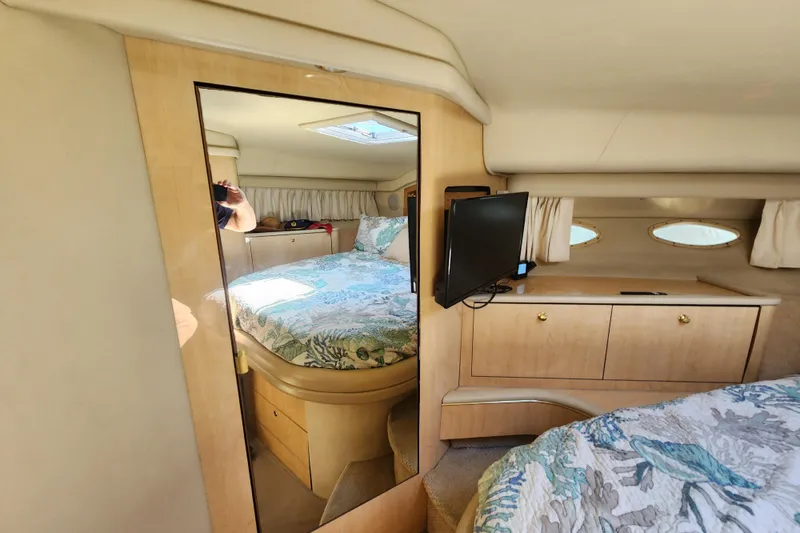 Slide: The Image of Interior of 2001 Sea Ray 400 Sedan Bridge with bed, mirror, and TV. - 21