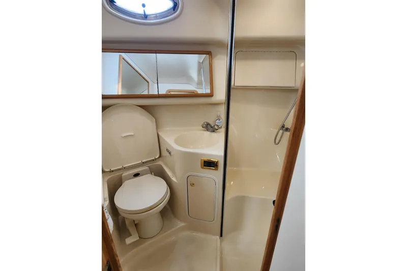 Slide: The Image of Bathroom interior of 2001 Sea Ray 400 Sedan Bridge yacht, featuring toilet and sink. - 22