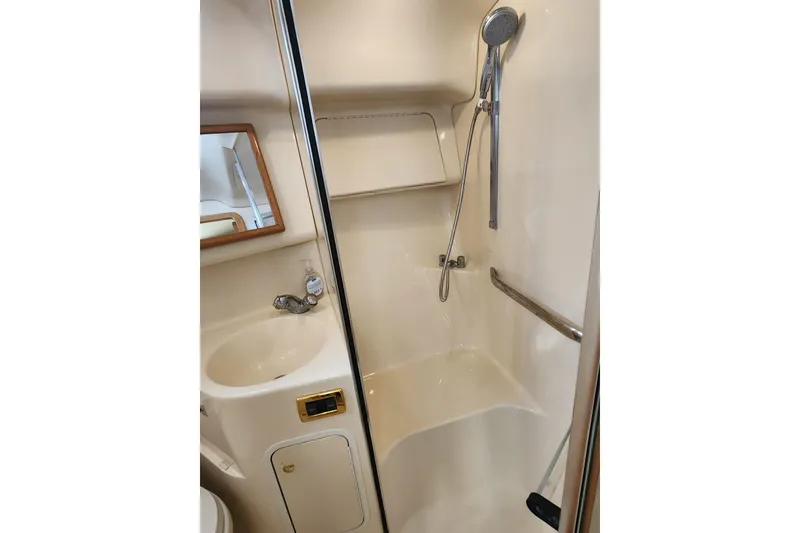 Slide: The Image of 2001 Sea Ray 400 Sedan Bridge bathroom with shower, sink, and mirror. - 23