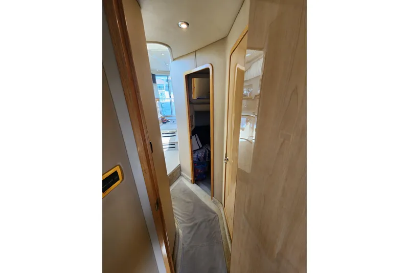 Slide: The Image of Interior hallway of 2001 Sea Ray 400 Sedan Bridge yacht, featuring wooden doors and modern lighting. - 24