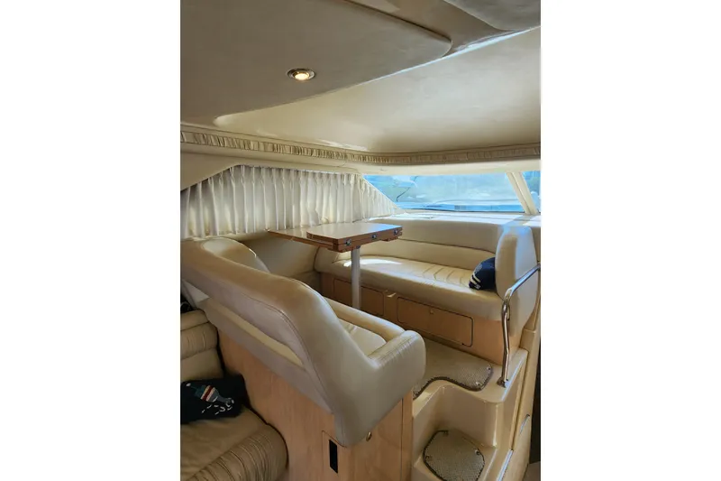 Slide: The Image of Interior of 2001 Sea Ray 400 Sedan Bridge yacht with plush seating and dining area. - 25