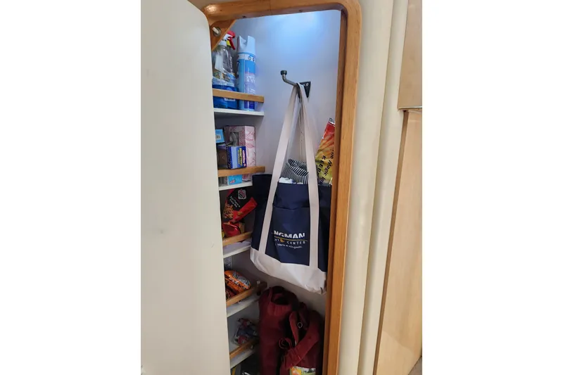 Slide: The Image of Storage closet on a 2001 Sea Ray 400 Sedan Bridge yacht, filled with bags and supplies. - 28