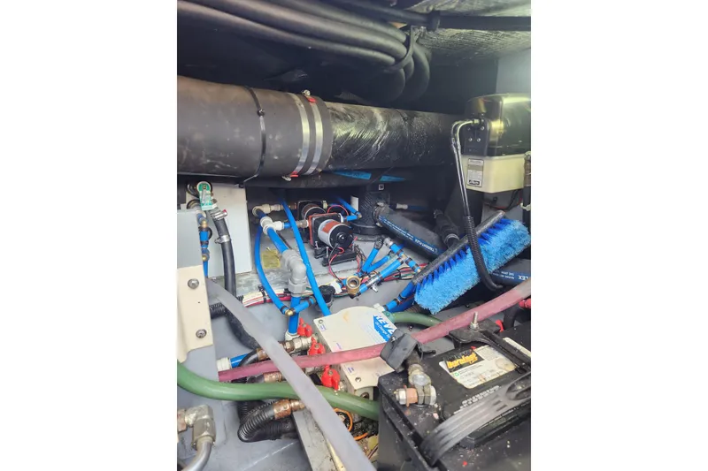 Slide: The Image of Engine room of a 2001 Sea Ray 400 Sedan Bridge with visible hoses and components. - 32