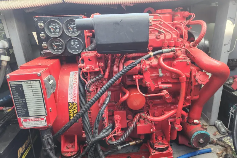 Slide: The Image of Engine compartment of a 2001 Sea Ray 400 Sedan Bridge with red mechanical components. - 33