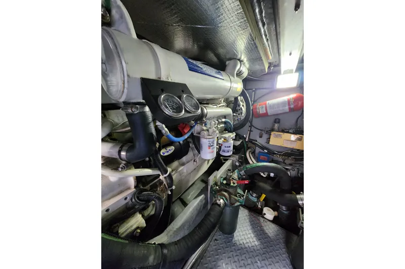 Slide: The Image of Engine room of a 2001 Sea Ray 400 Sedan Bridge with visible components and fire extinguisher. - 35