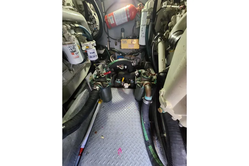Slide: The Image of Engine room of a 2001 Sea Ray 400 Sedan Bridge with visible components and fire extinguisher. - 36