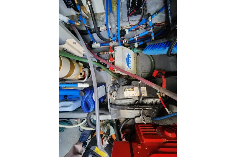 Slide: The Image of Engine room of a 2001 Sea Ray 400 Sedan Bridge with visible wiring and components. - 38