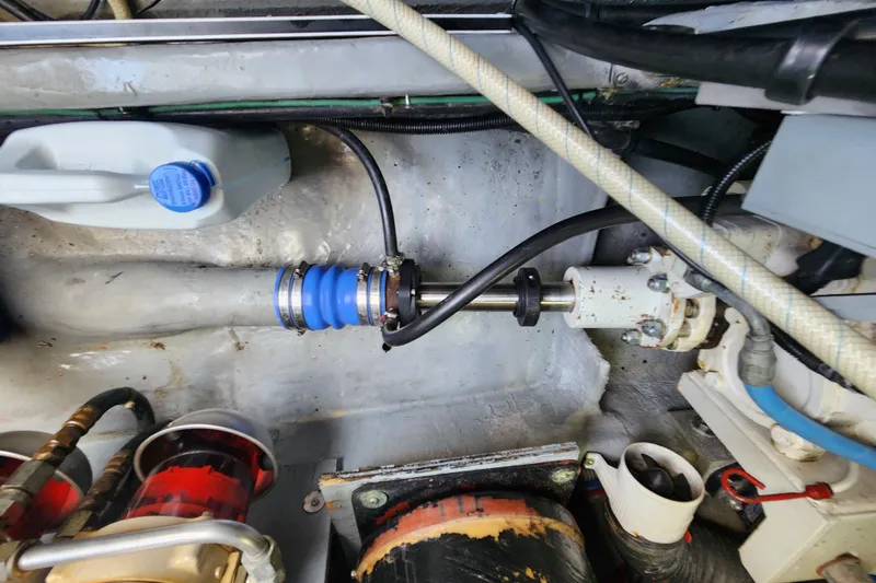 Slide: The Image of Engine compartment of a 2001 Sea Ray 400 Sedan Bridge, showcasing mechanical components and hoses. - 39