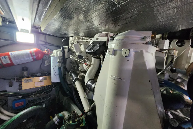 Slide: The Image of Engine room of a 2001 Sea Ray 400 Sedan Bridge yacht, featuring mechanical components. - 40
