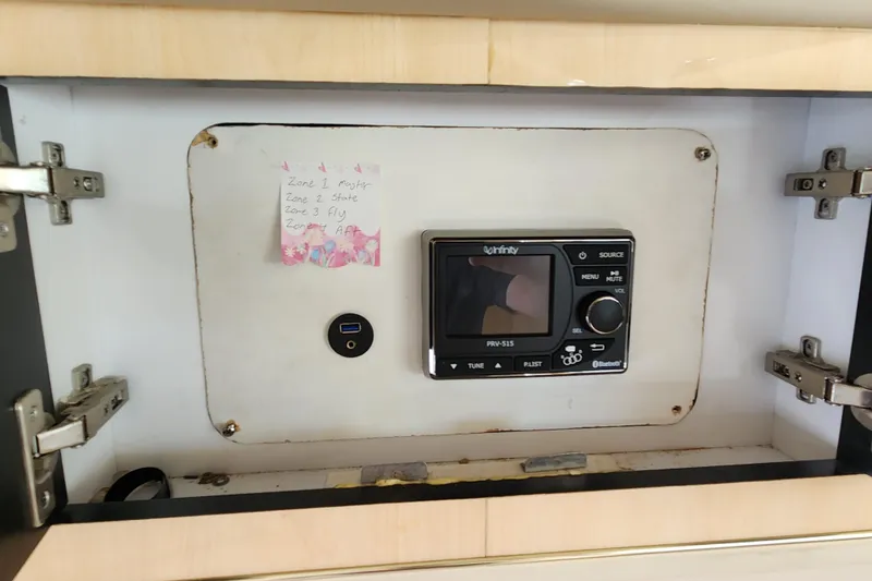 Slide: The Image of Audio control panel inside a 2001 Sea Ray 400 Sedan Bridge cabinet. - 41