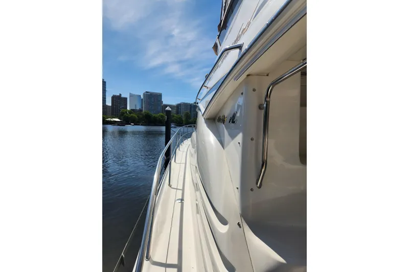 Slide: The Image of Side view of a 2001 Sea Ray 400 Sedan Bridge yacht docked by a city waterfront. - 5