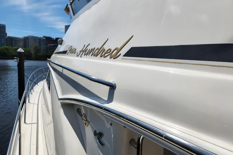 Slide: The Image of 2001 Sea Ray 400 Sedan Bridge yacht docked, showcasing sleek design and branding. - 6