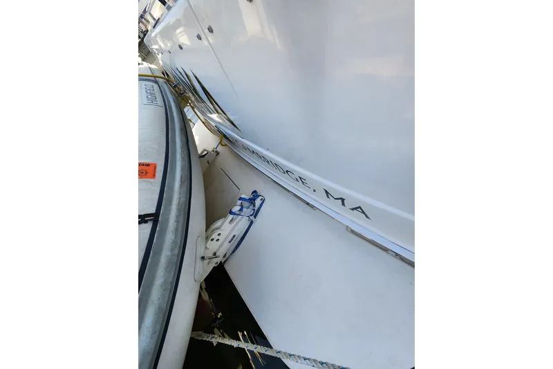 Slide: The Image of 2001 Sea Ray 400 Sedan Bridge docked, showing hull and adjacent inflatable boat. - 7