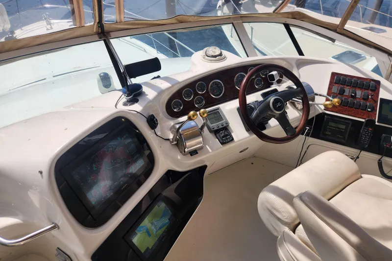 Slide: The Image of Cockpit of 2001 Sea Ray 400 Sedan Bridge with navigation and control systems. - 8