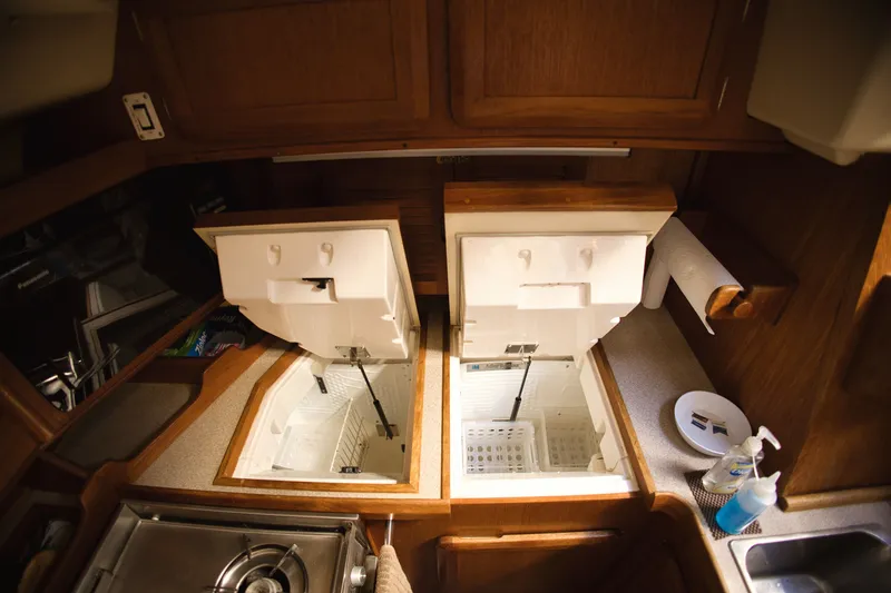 Slide: The Image of Interior of a 1994 Hunter Passage with open cooler compartments. - 14