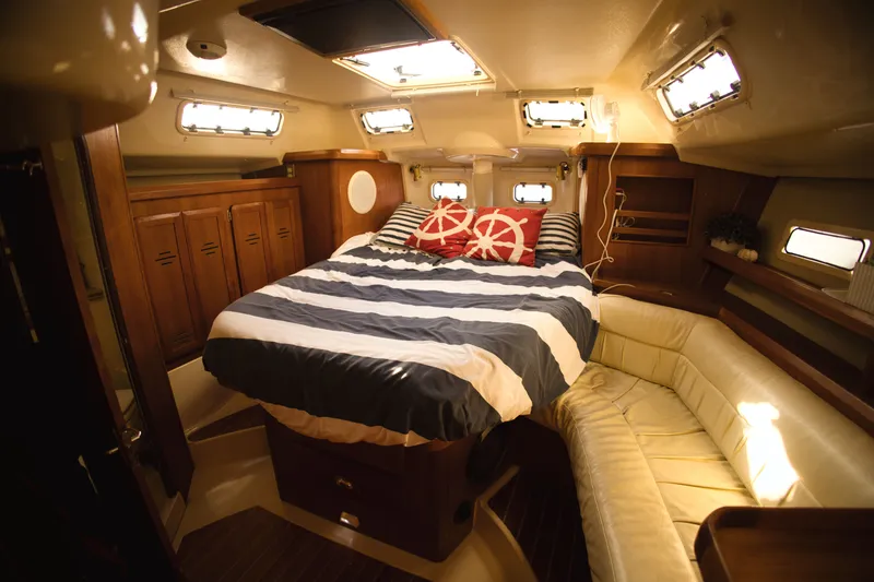 Slide: The Image of Interior of a 1994 Hunter Passage yacht with cozy bed and seating area. - 5